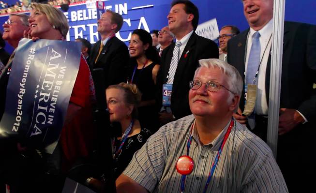 Washoe County GOP chairman David Buell, surrounded by the Nevada delegation, watches the Jumbotron during Mitt Romney's speech at the Republican National Convention in Tampa Thursday night on Aug. 30, 2012.