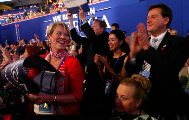 Nevada delegate Kim Bacchus and Lieutenant Governor Brian Krolicki exchange a glance and a smile during Mitt Romney's speech to the Republican National Convention Thursday night Aug. 30, 2012 in Tampa.