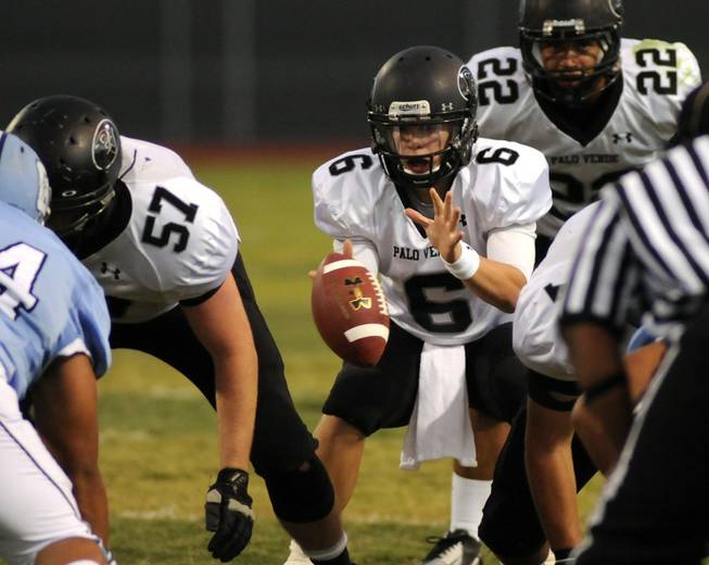 Palo Verde quarterback Parker Rost prepares to take a second half snap against host Centennial on Friday night.
