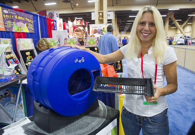 Ann Jolie, COO of Smart Choice Pet Products, demonstrates the Litter Spinner, a quick-cleaning cat litter box, during SuperZoo, a trade show for the pet industry, at the Mandalay Bay Convention Center Tuesday, Sept. 11, 2012.