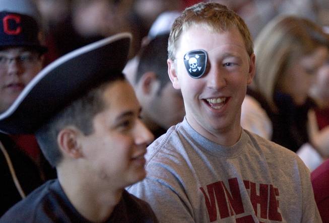 Washington State students Jeff Honnold, center, and his friend, Shane Porcincula, left, wear pirate costumes to the introductory press conference for football coach Mike Leach, on Tuesday, Dec. 6, 2011, in Pullman, Wash.