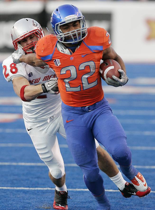 In this Dec. 3, 2011, file photo, Boise State running back Doug Martin (22) rushes past New Mexico's Bubba Forrest (28) during the first half of an NCAA college football game in Boise, Idaho.