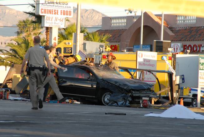 Metro Police investigate after a car crashed into a bus stop on Spring Mountain Road east of Decatur Boulevard, killing four people, on Thursday, Sept. 13, 2012.