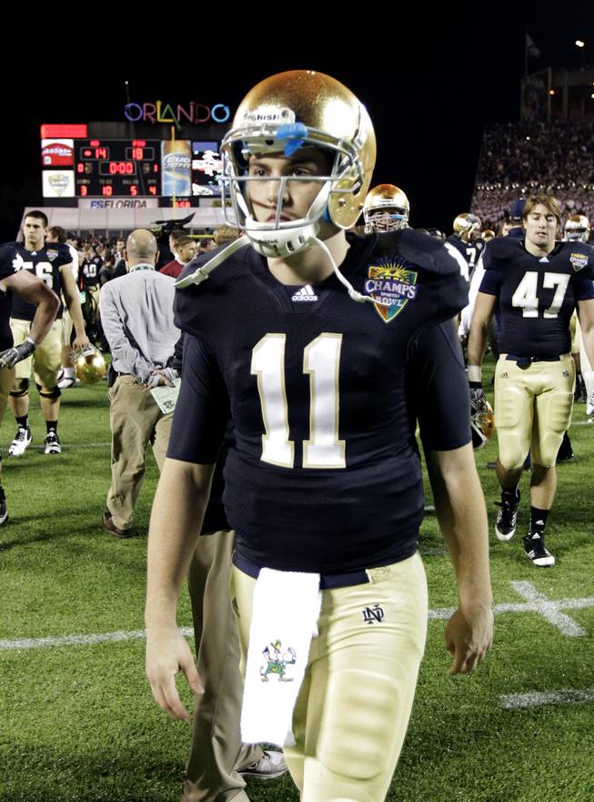 In this file photo, Notre Dame quarterback Tommy Rees walks off of the field after an 18-14 loss to Florida State in the Champ Sports Bowl.