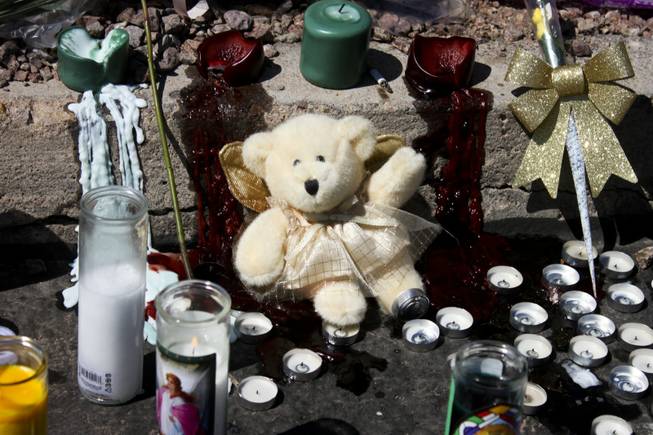 Burnt out candles along with other mementoes as seen at the memorial site of the bus stop crash Friday, Sept. 14, 2012.