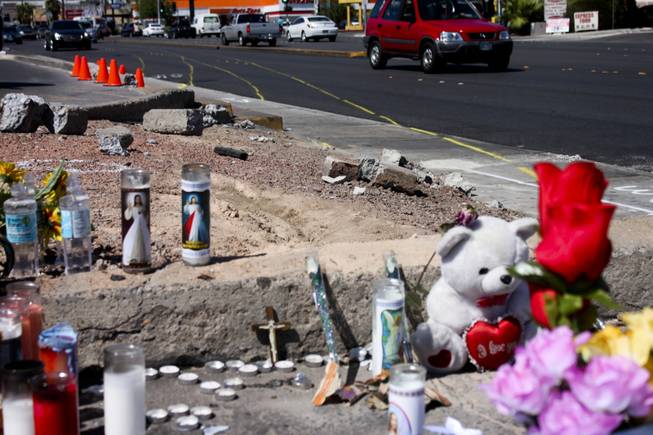 Track markers detailing the trajectory course of the car involved in the bus stop crash are seen in the background of the memorial site of the accident Friday, Sept. 14, 2012.