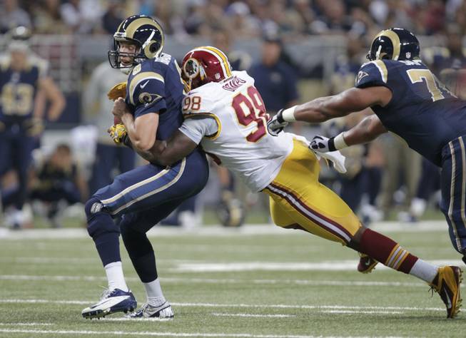 St. Louis Rams quarterback Sam Bradford, left, is fumbles as he is sacked by Washington Redskins outside linebacker Brian Orakpo during the first quarter of an NFL football game Sunday, Sept. 16, 2012, in St. Louis. 
