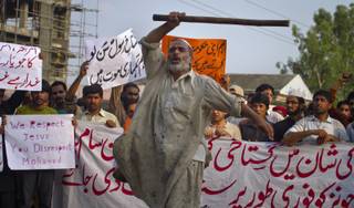 A Pakistani worker shouts anti U.S. slogans during a rally in Islamabad, Pakistan on Saturday, Sept. 15, 2012 as part of widespread anger across the Muslim world about a film ridiculing Islam's Prophet Muhammad. The banner at bottom reads, 