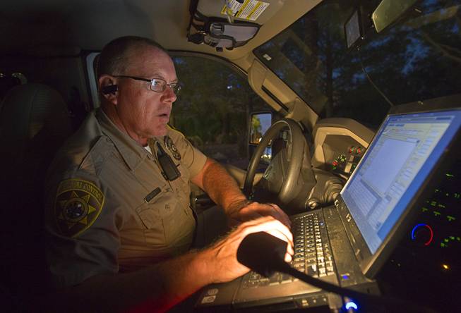 With the priority calls taken care off and no new calls coming in, Clark County Animal Control Officer Darryl Duncan uses the laptop in his truck to go through a backlog of lower priority calls Thursday Sept. 20, 2012.