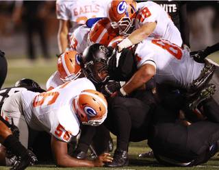 The Bishop Gorman defense stops Servite running back Andrew Moore at the line during their game at Cerritos College in Norwalk, Calif., Friday, Sept. 21, 2012.