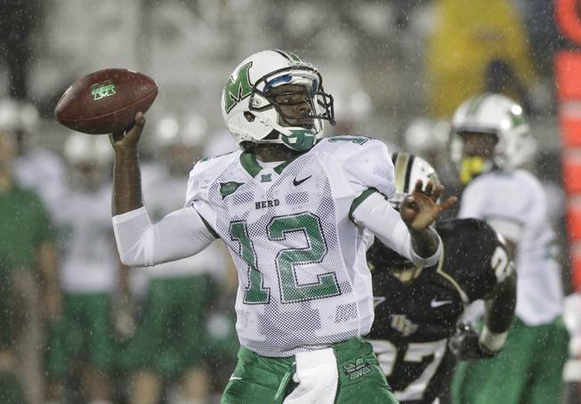 This Oct. 8, 2011 file photo shows Marshall quarterback Rakeem Cato (12) looking for a receiver during the first half of an NCAA college football game against Central Florida, in Orlando, Fla.