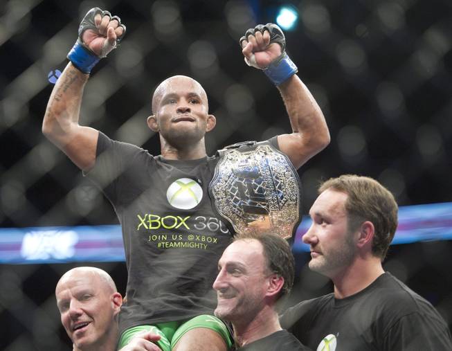 Demetrious Johnson holds the winning belt after defeating Joseph Benavidez during the flyweight championship title bout at UFC 152 in Toronto on Saturday, Sept. 22, 2012. 