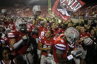 UNLV football players celebrate their first victory of the season, a 38-35 win over Air Force at Sam Boyd Stadium on Saturday night.