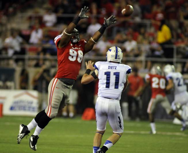 Rebel defensive end James Boyd leaps to block a pass thrown by Air Force quarterback Connor Dietz during the first quarter of the Mountain West season opener at Sam Boyd Stadium on Saturday night.