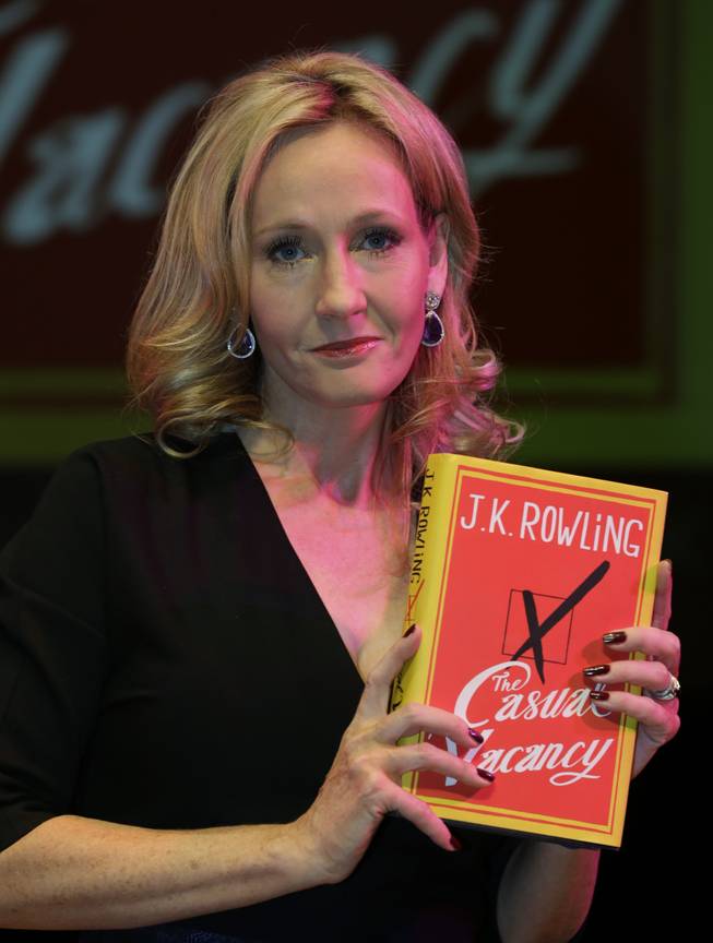 British writer J.K. Rowling poses for the photographers with her new book, entitled: "The Casual Vacancy," at the Southbank Centre in London, Thursday, Sept. 27, 2012. The book, published by Little, Brown Book Group, is Rowling's first novel for adults after writing the Harry Potter series.