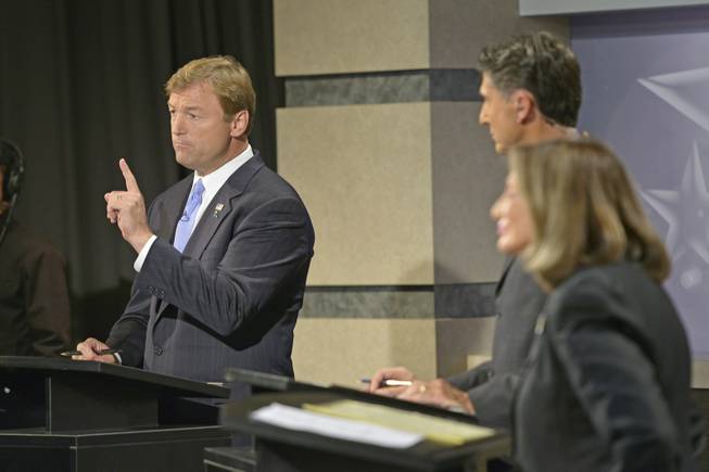 Sen. Dean Heller, R-Nev., debates his challenger, Rep. Shelley Berkley, D-Nev., at the Reno public television studios, Sept. 27, 2012 as Mitch Fox, center, moderates.