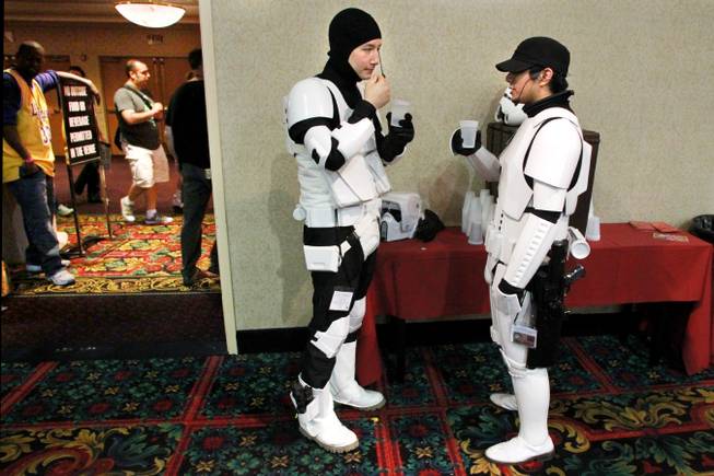 Dressed as storm troopers from Star Wars, Emmanuel Chen, left, and Perry Caddauan take a water break at the Las Vegas Comic Expo Saturday, Sept. 29, 2012.