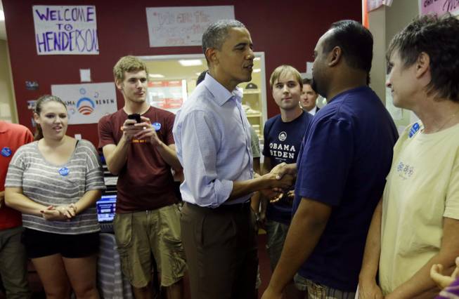 President Barack Obama greets volunteers during a visit to a local campaign office, Monday, Oct. 1, 2012 in Henderson, Nev. 