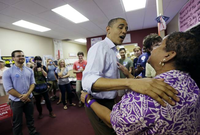 President Barack Obama greets supporters during a visit to a local campaign office Monday, Oct. 1, 2012, in Henderson.