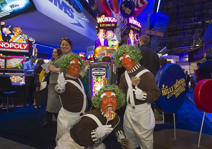 "Oompa Loompas," clockwise from left, Brian Thomas, Dimos Greko, and Christophe Zajack-Denek promote the Willie Wonka-themed slot machine at the WMS Gaming booth during the Global Gaming Expo (G2E) at the Sands Expo Center Tuesday, Oct. 2, 2012.