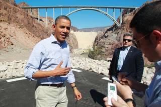 President Barack Obama talks to the media while visiting the Hoover Dam during a break from debate preparations Tuesday, Oct. 2, 2012.