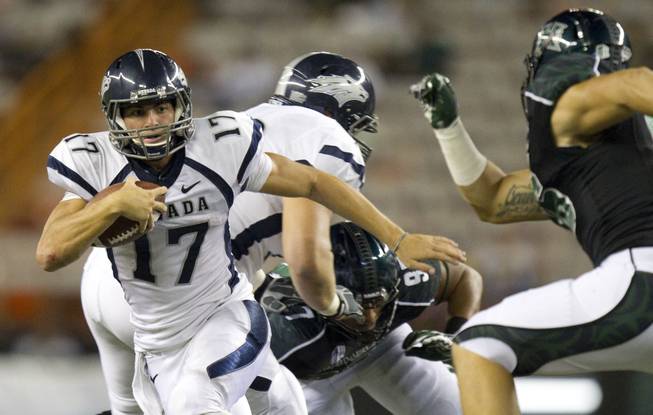 UNR quarterback Cody Fajardo (left) cuts away from Hawaii linebacker Brenden Daley during the Wolf Pack's blowout victory on Saturday, Sept. 22, 2012. The difference in talent in the Mountain West right doesn't get any larger than between these two teams.