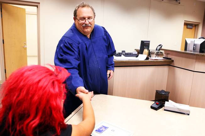 Judge Stephen Compan hands Diana, 15, her certificate of graduation from the diversion court program held at Clark County Family Courts in Las Vegas on Wednesday, October 3, 2012.