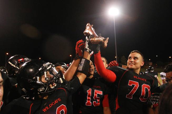 From left, Las Vegas's Vince Castro, Joshua Mayfield and Donny Francis celebrate defeating Rancho in their annual "Bone Game" Friday, Oct. 5, 2012. Las Vegas won 45-0 for their 17th consecutive win in the series.