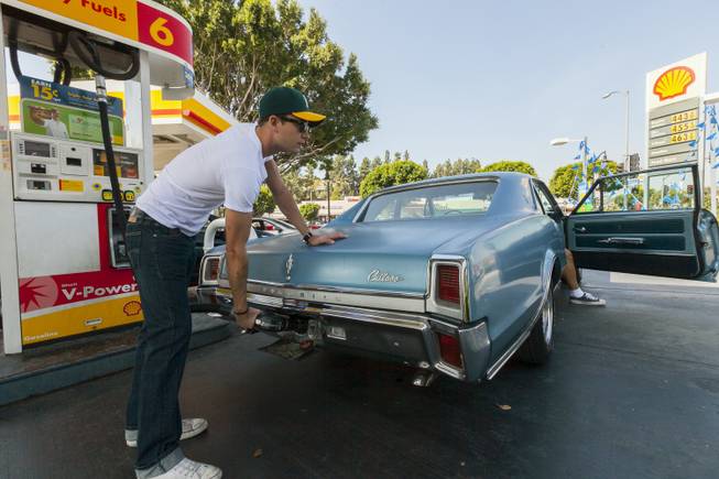Motorist Tony Klein fills up his 1967 Cutlass V-8 at a gas station in Los Angeles Thursday, Oct. 4, 2012. Motorists in California paid an average of $4.232 per gallon Wednesday. That’s 45 cents higher than the national average and exceeded only by Hawaii among the 50 states.