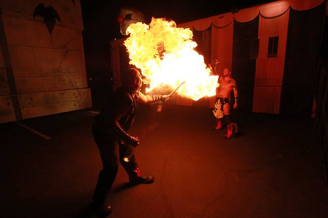 Scorch the Clown from Freakshow Wrestling spits fire during a performance at the Freakling Brothers Trilogy of Terror haunted house in north west Las Vegas Saturday, Oct. 6, 2012.