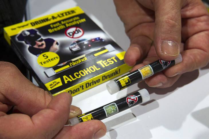 Drink-A-Lyzer alcohol tests are displayed during the annual National Association of Convenience Stores (NACS) trade show at the Las Vegas Convention Center Monday, Oct. 8, 2012. The single-use alcohol tester changes color from yellow to green depending on blood alcohol content and retails for about $5.00.
