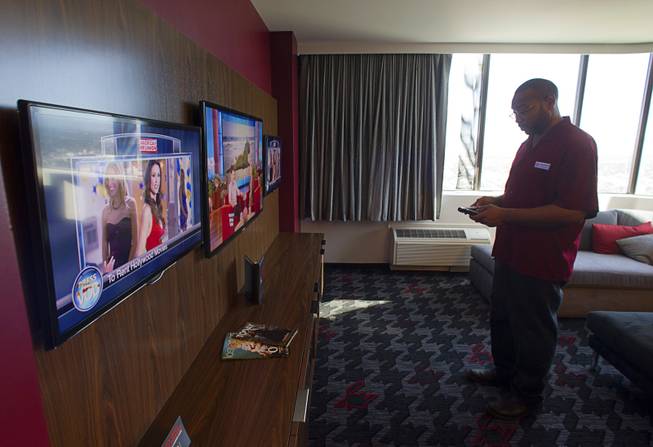 Housekeeping supervisor Jermaine Vincent checks the operation of television remotes in a renovated suite at the D Las Vegas in downtown Las Vegas Tuesday, Oct. 9, 2012. The casino, formerly Fitzgeralds, is celebrating it's rebranding and renovation with festivities this weekend.