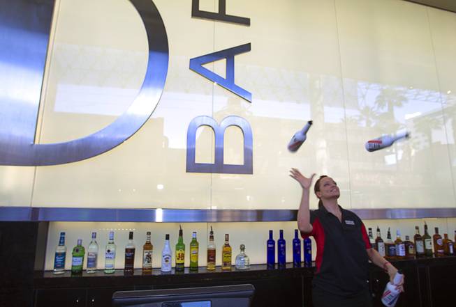 Flair bartender Erin Ferreira juggles bottles at the D Las Vegas in downtown Las Vegas Tuesday, Oct. 9, 2012. The casino, formerly Fitzgeralds, is celebrating it's rebranding and renovation with festivities this weekend.