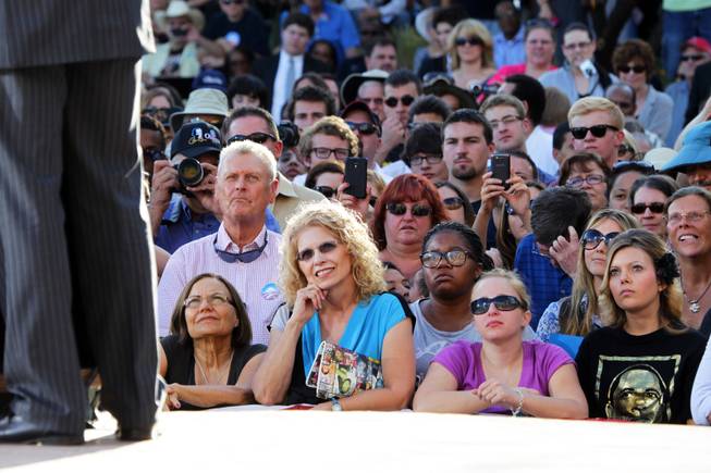 Supporters listen as former President Bill Clinton speaks during a ...