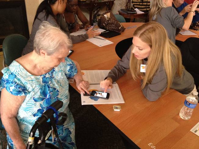 AT&T employees help residents learn to use a smart phone at the Atria Sutton senior living home, 3185 E. Flamingo Road, on Oct. 10, 2012. The workshop was part of the nationwide AT&T Reconnect Tour, which teaches seniors the basics of using a smart phone and the Internet.