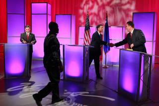 Third Congressional District  candidates Dr. Joe Heck, left, wraps up while moderator Mitch Fox shakes John Oceguera's hand after a debate at Vegas PBS Thursday, Oct. 11, 2012. Photography was not permitted during the debate.