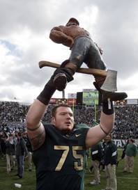 Michigan State offensive tackle Jared McGaha (75) holds the Paul Bunyan Trophy after the Spartans defeated Michigan 28-14 in an NCAA college football game in East Lansing, Mich., Saturday, Oct. 15, 2011. The college rivalry trophy is awarded to the winner of the football game between Michigan and Michigan State. 