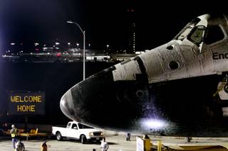 A welcome home sign is displayed on the turn as space shuttle Endeavour leaves Los Angeles International Airport hangar onto the streets in Los Angeles on Friday, Oct. 12, 2012. Endeavour's 12-mile road trip kicked off shortly before midnight Thursday as it moved from its Los Angeles International Airport hangar en route to the California Science Center, its ultimate destination, said Benjamin Scheier of the center. 
