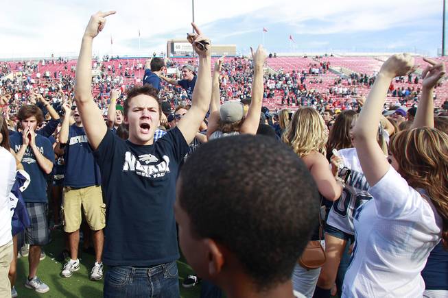 UNR fans storm the field and chant after their game against UNLV Saturday, Oct. 13, 2012 at Sam Boyd Stadium. UNR came from behind and won the game, for the eighth consecutive time, 42-37.