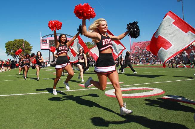 UNLV cheerleaders lead the team out for their game against UNR Saturday, Oct. 13, 2012 at Sam Boyd Stadium. UNR came from behind and won the game, for the eighth consecutive time, 42-37.