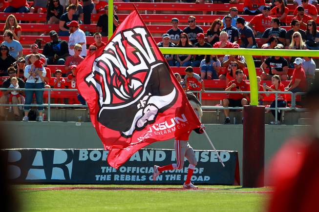 Hey Reb runs with a UNLV flag after scoring against UNR during their game Saturday, Oct. 13, 2012 at Sam Boyd Stadium. UNR came from behind and won the game, for the eighth consecutive time, 42-37.
