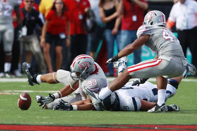 UNLV defensive lineman Sonny Sanitoa reaches for a loose ball that was eventually recovered by UNR, picking up 21 yards on the play Saturday, Oct. 13, 2012 at Sam Boyd Stadium. UNR came from behind and won the game, for the eighth consecutive time, 42-37.