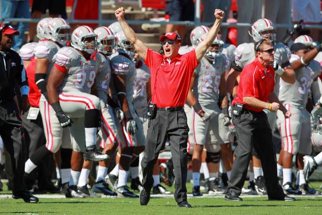 UNLV coach Bobby Hauck celebrates a touchdown against UNR during the first half of their game Saturday, Oct. 13, 2012 at Sam Boyd Stadium.