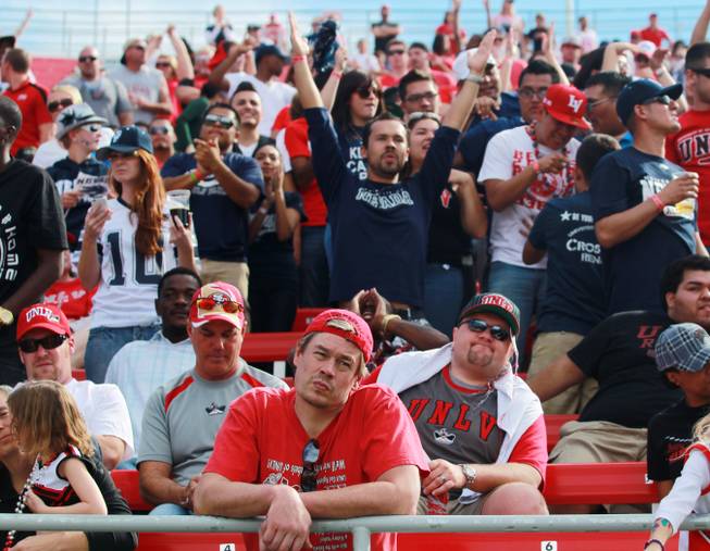 UNR fans celebrate while UNLV fans look despondent after UNR scored to put the game out of reach 42-31 Saturday, Oct. 13, 2012 at Sam Boyd Stadium.