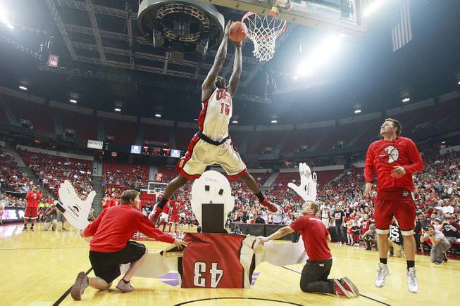 UNLV forward Anthony Bennett leaps over a giant cut out of Mike Moser during the dunk contest at the team's First Look scrimmage Thursday, Oct. 18, 2012 at the Thomas & Mack.