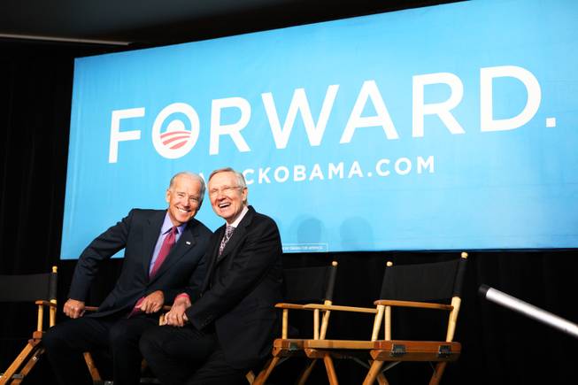 Vice President Joe Biden, left, and Senate Majority Leader Harry Reid, D-Nev. sit together during a rally at the Culinary Academy in Las Vegas on Thursday, October 18, 2012.