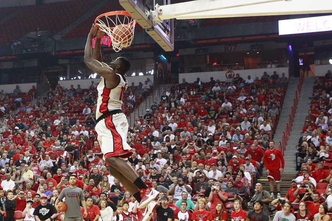 UNLV guard Katin Reinhardt, in red shirt standing on steps on the right, watches as forward Anthony Bennett reverse dunks a pass thrown from Reinhardt during the slam dunk portion of UNLV's First Look scrimmage Thursday, Oct 18, 2012.