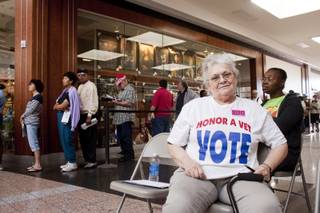 As an observer for the Democratic Party, Sam Michael watches for quality control at the voting booths at Boulevard Mall on the first day of early voting, Saturday, Oct. 20, 2012.