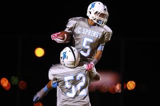Canyon Springs lineman Alonzo Pittman lifts running back D.J. Pumphry into the air after a touchdown.