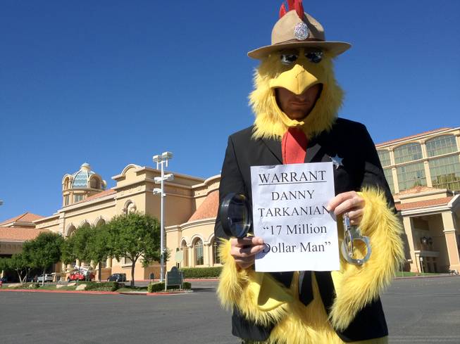 Paul Smith, of the Nevada Democratic Party, wears a "U.S. Marshal chicken" suit to draw attention to the debt of Danny Tarkanian, a Republican candidate for the 4th Congressional District, and Tarkanian's failure to attend a discussion session with the Las Vegas Latin Chamber of Commerce on Friday at the Suncoast Hotel and Casino.